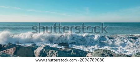 Seascape of the black sea beach. Sea waves crash and splash on rocks. View of the sea, ocean. Natural soft blue background. View of the sea, ocean. Batumi, Georgia