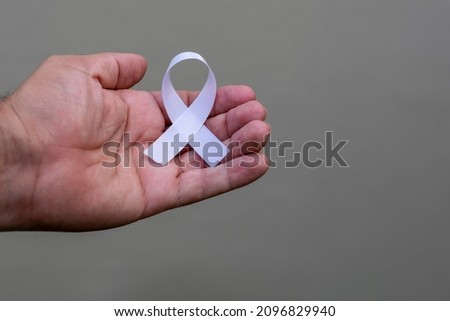 January White. hand with white ribbon. represents a mental health prevention program.
