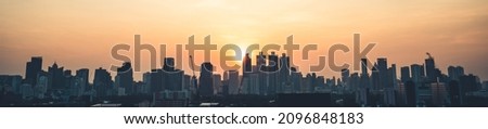Beautiful sunset cityscape and high-rise buildings in metropolis city center . Downtown business district in panoramic view .