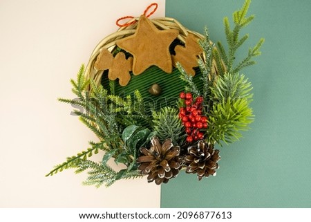 Christmas decoration from the branches of a Christmas tree, cones, berries, branches and gingerbread lie on the background