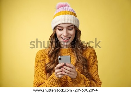 Amazed surprised cute girl receive good news reading exciting message hold smartphone widen eyes smiling mobile phone display, playing awesome cellphone game texting, send pics winters vacation
