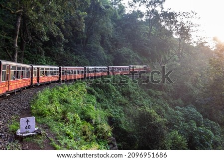 View from moving train in Shimla on arch bridge over mountain slopes, beautiful view, one side mountain, one side valley. Toy train from Shimla to Kalka in Himachal Pradesh, India. Honeymoon Place. Royalty-Free Stock Photo #2096951686
