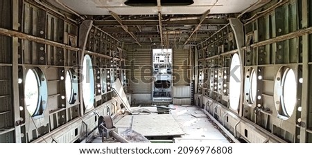 A fuselage that has been damaged and is no longer in use looks untouched by humans Royalty-Free Stock Photo #2096976808