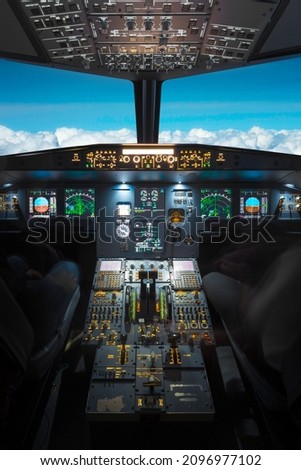 inside a big jet flying plane cockpit,flying above clouds Royalty-Free Stock Photo #2096977102