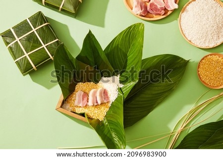 Vietnamese traditional Chung cake with dong leaf pork glutinous rice in green background for holiday food advertising , top view Royalty-Free Stock Photo #2096983900