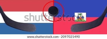 Top view hockey puck with Netherlands vs. Haiti command with the sticks on the flag. Concept hockey competitions