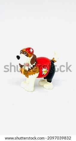 Smiling saint bernard with a red dress and a help kit on a white isolated background