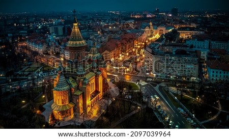 Aerial view of the city center of Timisoara with holiday lights and the Orthodox Metropolitan Cathedral. Photo taken on 26th of December 2021, in Timisoara, Timis County, Romania. Royalty-Free Stock Photo #2097039964