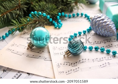 Christmas balls with beads on note sheets, closeup