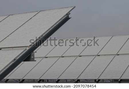 Photovoltaic power plant in winter.Problems in production of energy covered with snow panel