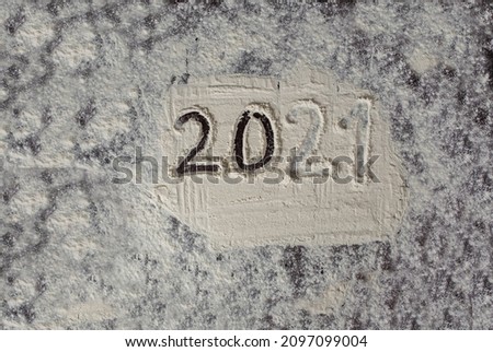 Abstract background of a photo of the outgoing year 2021. Flour drawing.