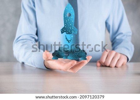 Startup business concept, Businessman holding in hand icon rocket is launching and soar flying out from screen with network connection on dark background.Low poly,polygonal.Profit, rise, development.