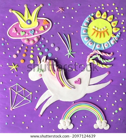 Cute flying unicorn pony horse in space. Handmade clay illustration decorated with rainbow, diamond, spaceship. Nursery baby art craft.