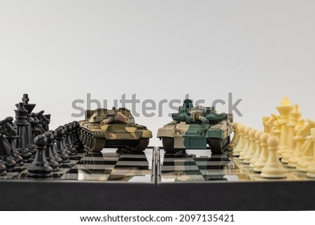 toy tanks on a chessboard. space for printing text. background picture.