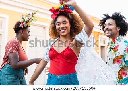 Woman dance during Carnival Day in Brazil. People in costume enjoy Brazilian party of Carnaval in the street. Royalty-Free Stock Photo #2097135604