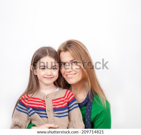 Mother embracing her daughter, isolated on white.