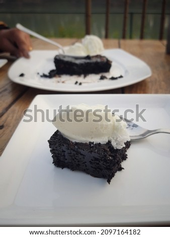 Picture of chocolate brownie with hot chocolate and vanilla ice cream.