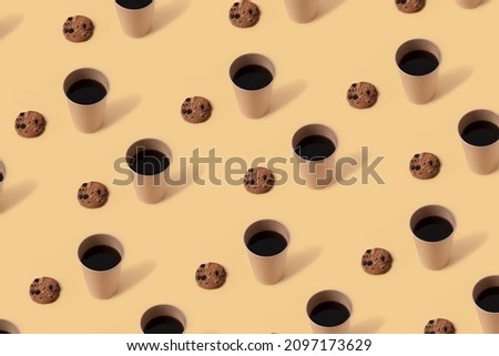 Black coffee in paper cup and chocolate chip cookies on beige background. Seamless repeating pattern.