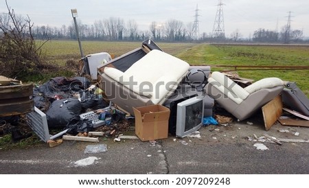 Italy, December 2021 Illegal open-air waste dump near Milan city downtown  ( Vaiano Valle ) - tons of garbage waste, polluting plastics abandoned in nature - environmental sustainability and mafia Royalty-Free Stock Photo #2097209248