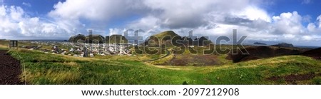 Panorama view on the Vestmannaeyjar islands in Iceland with changing weather in one picture