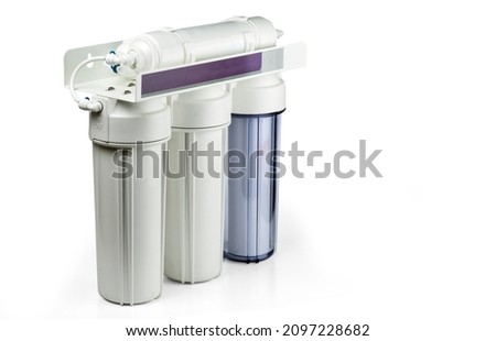Three stage home water filtration system isolated on a white. Royalty-Free Stock Photo #2097228682
