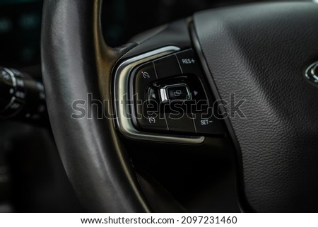 Cruise control switch closeup. Adaptive cruise control leaver. Cruise control on steering wheel. Royalty-Free Stock Photo #2097231460