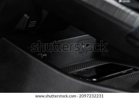 Wireless mobile charger in the modern car. Portable wireless car charger for smartphone. Phone charging on  wireless charger. Royalty-Free Stock Photo #2097232231