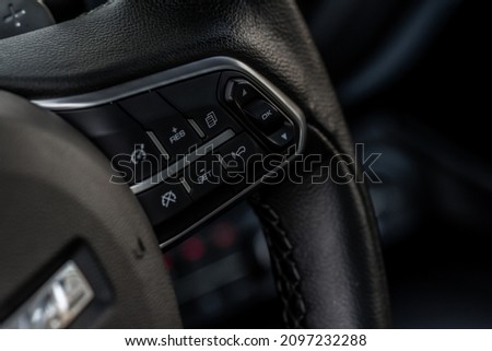 Cruise control switch closeup. Adaptive cruise control leaver. Cruise control on steering wheel. Royalty-Free Stock Photo #2097232288