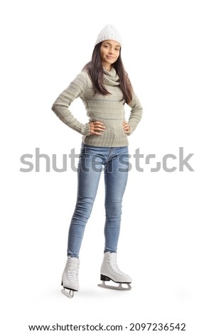 Full length portrait of a young woman in casual clothes wearing ice skates isolated on white background