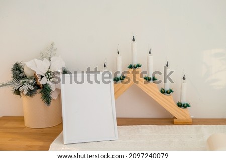 Christmas photo frame mock up template with decoration on wooden table. High quality photo
