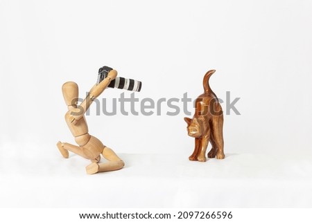 Wooden mannequin, on a white background. Photographer.