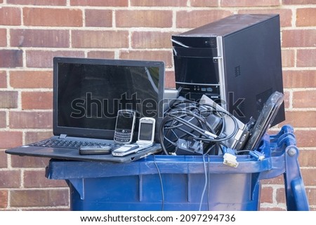 Old computer hardware and mobile devices put into a recycling container  High quality photo