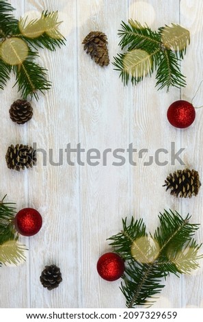 Christmas card with copy space for text, holiday greeting or template, red Christmas balls and spruce branch, and cone.