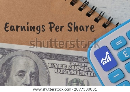 EPS Earnings Per Share concept with money and calculator.