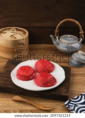 Ang Kue (Kue Ku) or Kue Thok, steamed Chinese pastry of glutinous rice flour with sweet mung bean paste filling. Sticky, chewy texture. Served on wooden background. Selective focus image.
 Royalty-Free Stock Photo #2097361219