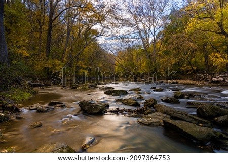 A scenic view of a river flowing in the forest in White Clay Creek State Park, Newark, Delaware Royalty-Free Stock Photo #2097364753