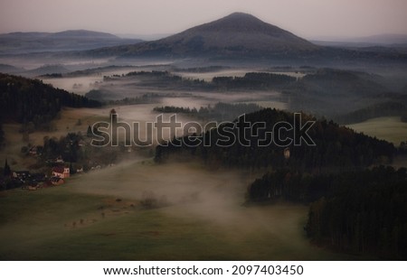 An Aerial view of a foggy valley at sunrise in Bohemian Switzerland