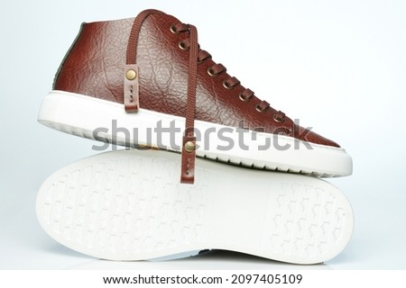 White rubber sole with brown leather sneakers isolated