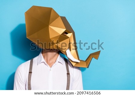 Photo of eccentric extravagant guy dressed wild animal mask looking empty space isolated blue color background
