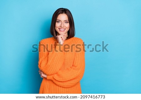 Portrait of attractive cheerful girl wearing cosy clothes making decision copy space isolated over bright blue color background