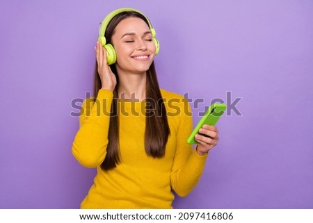 Photo of young pretty lady enjoy sound headphones use mobile dream isolated over purple color background
