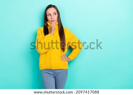 Photo of thoughtful unsure lady dressed yellow pullover arm chin looking empty space isolated teal color background