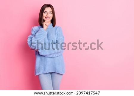 Portrait of attractive minded cheerful brown-haired girl making decision copy space isolated over pink pastel color background