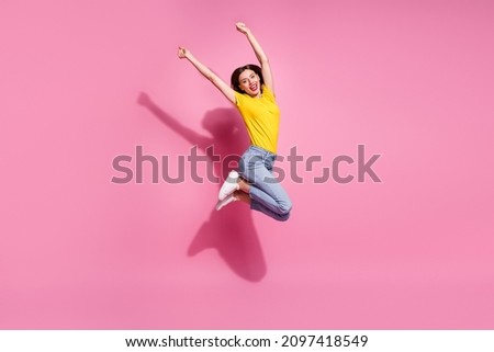 Photo of sweet lucky young woman wear yellow outfit jumping high rising arms smiling isolated pink color background Royalty-Free Stock Photo #2097418549