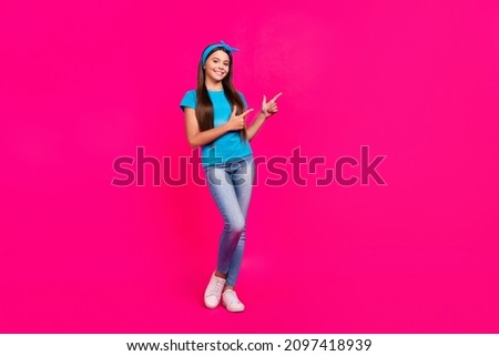 Full length body size view of attractive cheerful girl showing copy space ad isolated over bright pink magenta color background