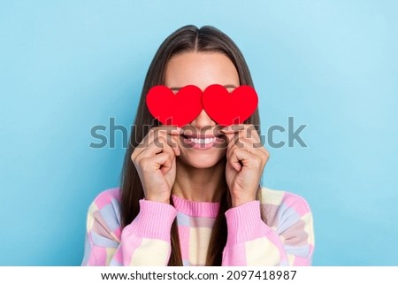 Photo of shy lady hold two little heart hide eyes blind date concept wear casual clothes isolated blue color background
