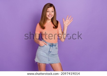 Portrait of attractive cheerful girl waving you hi hello congrats isolated over bright violet purple color background