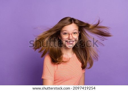 Portrait of attractive cheerful brown-haired girl nerd geek hair flying isolated on bright violet purple color background