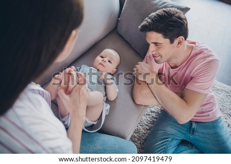 Portrait of attractive cheerful married spouses mommy daddy babysitting playing good morning at home indoors Royalty-Free Stock Photo #2097419479