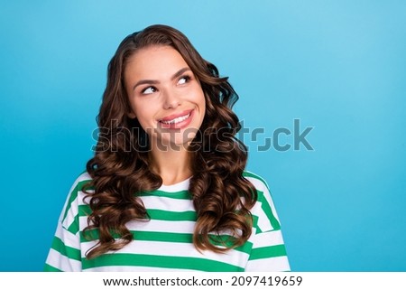 Photo of impressed brunette millennial lady look empty space wear green t-shirt isolated on blue color background